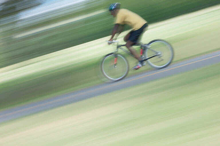 Cyclist riding downhill very fast